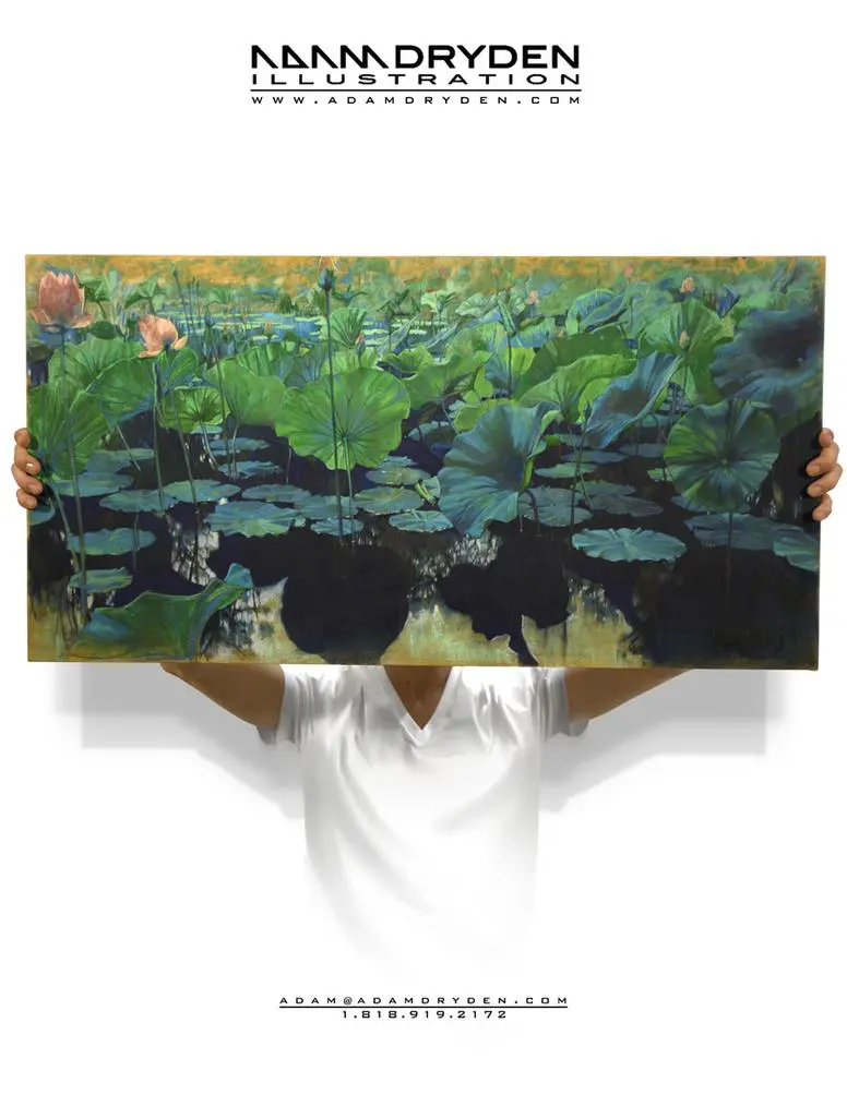 A person holding up a painting of water lilies.